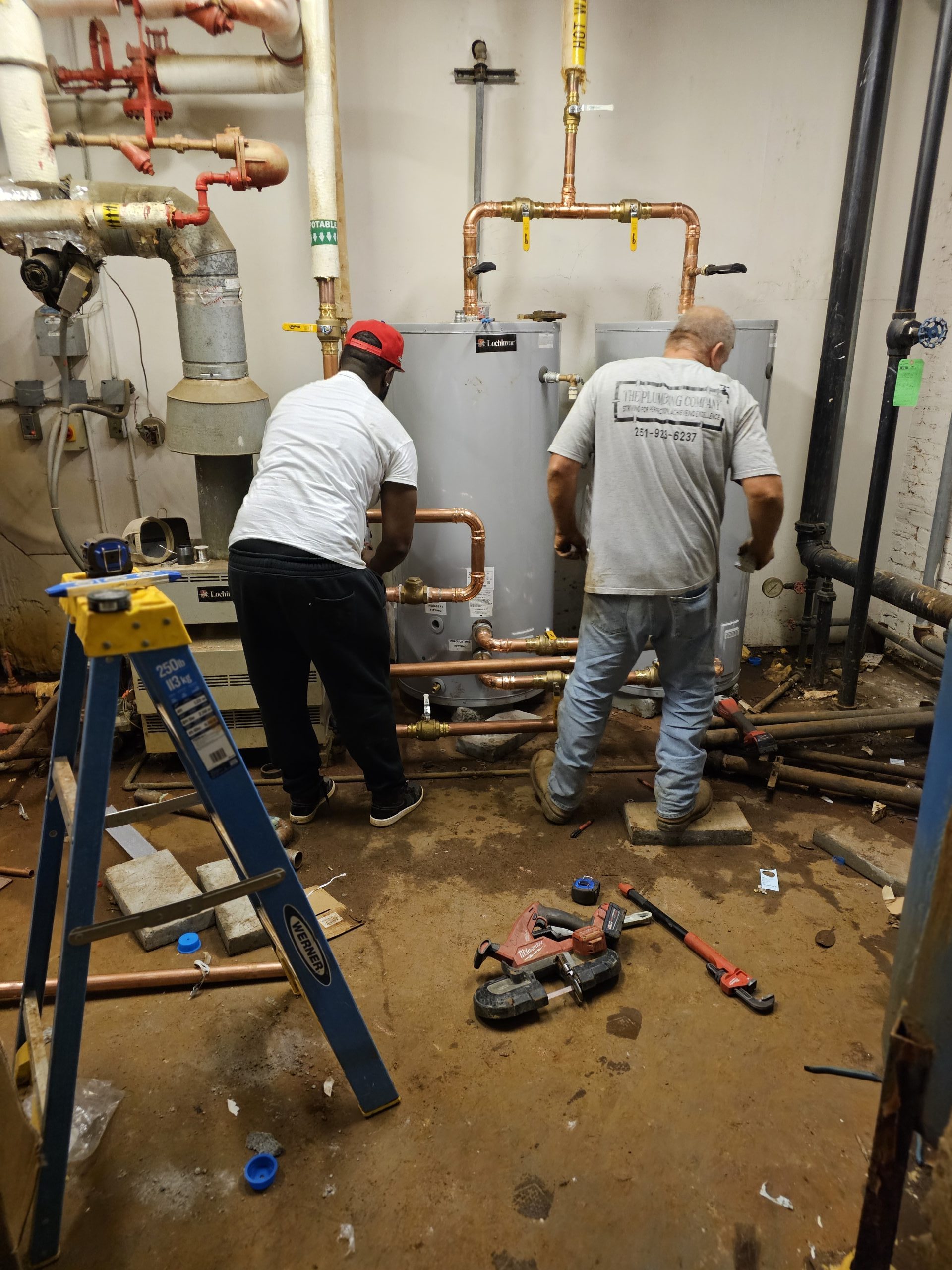 workers installing a new water heater system